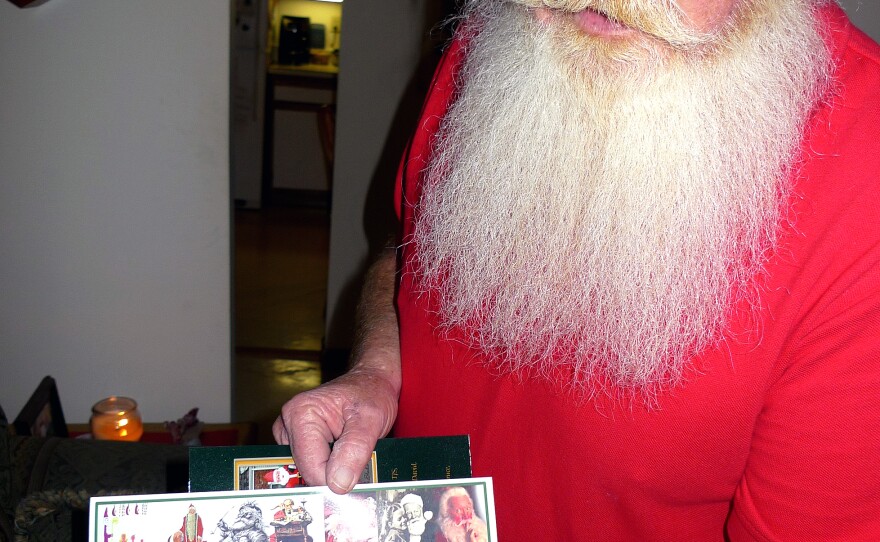 Scott Calkin, aka Cape Cod Santa, shows his diploma from the International University of Santa Claus.