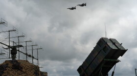 Ukrainian Air Force F-16 fighter jets fly over a Patriot air and missile defense system in an undisclosed location in Ukraine, on Aug. 4, 2024.