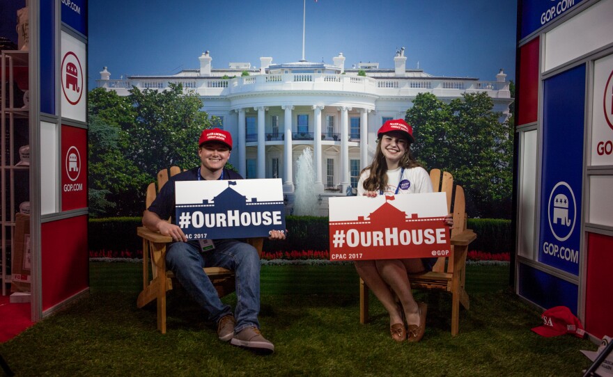 Paul Smyth (left) and Hannah Maclnnis of the Republican National Committee pose at a booth at the Gaylord National Resort & Convention Center during the conference.