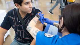 Armando Hernandez receives a COVID-19 vaccine at a San Diego County community vaccination event at the Cross Border Express in San Diego, Sept. 1, 2023.