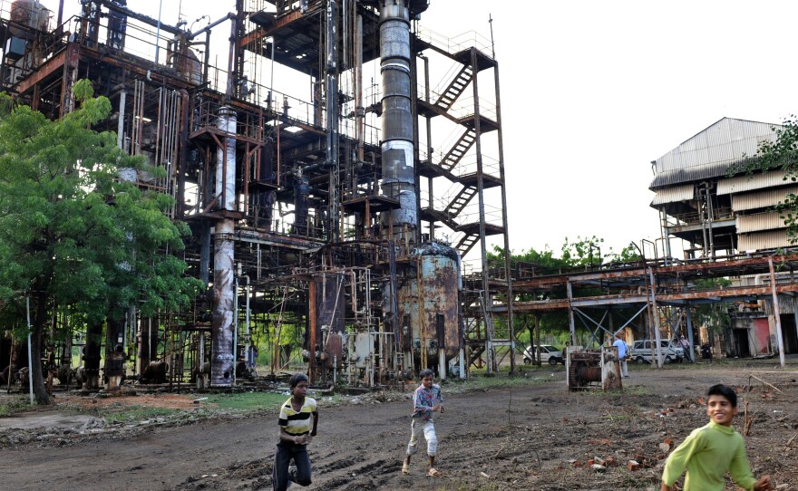 In this photograph from 2009, children play in front of the Union Carbide factory in Bhopal, India. Twenty-five years prior, in 1984, it was the site of a deadly gas leak that killed thousands of people.