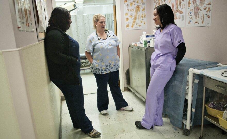 Peggy Renzi, middle, talks to her teammates Erica Heressy, left, and Erica Webster, right. The three are part of a team of nurses at the Bowie Health Center emergency room in Bowie, Md., who have joined together to lose weight.