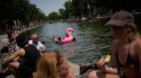 Parisians bath in the Canal Saint-Martin in Paris, as the national weather service, Meteo France, placed 54 departments, about half the country, under a red heat wave alert, Tuesday, June 23, 2026.