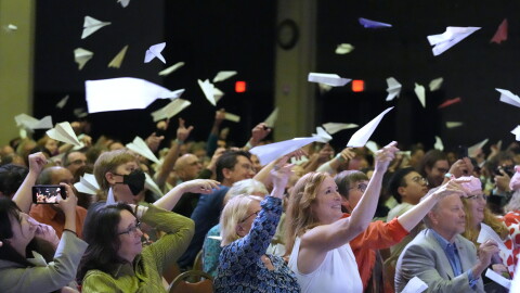 Audience members toss paper airplanes during the 2025 Ig Nobel Prize award ceremony in Boston, Mass.