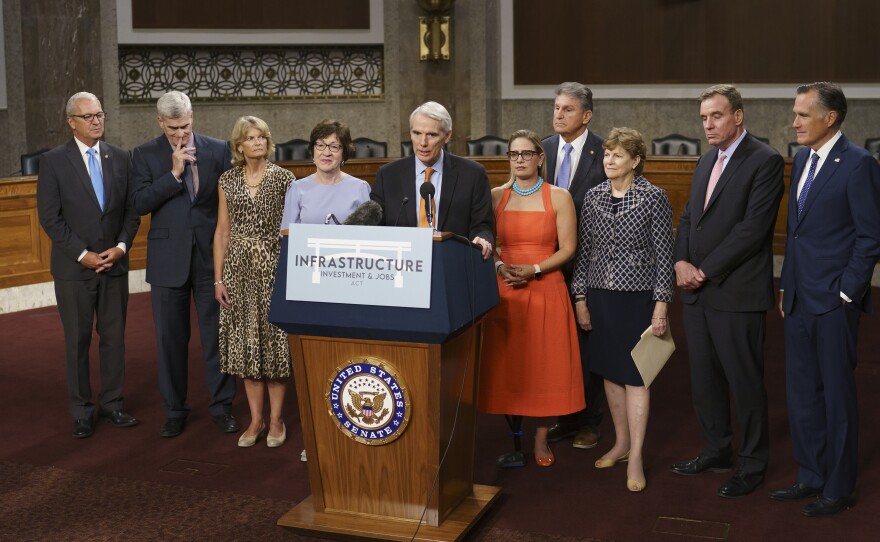 The bipartisan group of senators who are behind the infrastructure package talk to the press on July 28.
