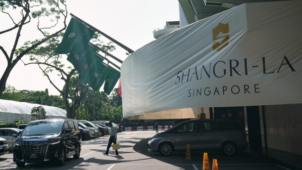 A man walk near the entrance of the Shangri-La Hotel, the venue for the International Institute for Strategic Studies (IISS) Shangri-La Dialogue, Asia's annual defense and security forum, in Singapore, Thursday, May 28, 2026.