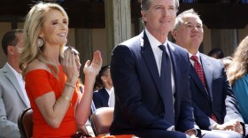 In this July 1, 2019, file photo, First Partner Jennifer Siebel Newsom, left, attends a big signing ceremony with her husband, Gov. Gavin Newsom, right, at Sacramento City College in Sacramento, Calif. 