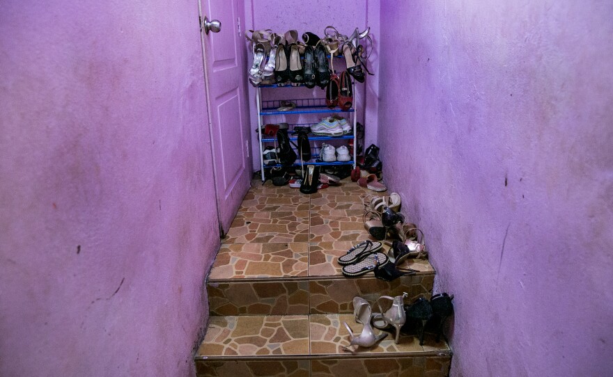 Shoes line the stairway by the living quarters for sex workers at a bar in Pattaya.