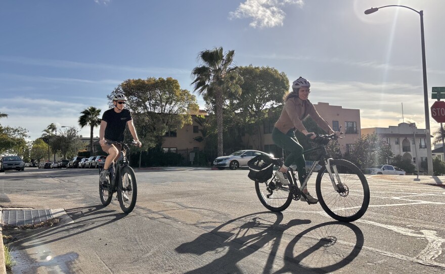 Alex Gerlock and Monica De La Cruz ride their bicycles through their neighborhood of Golden Hill, Feb. 18, 2026.