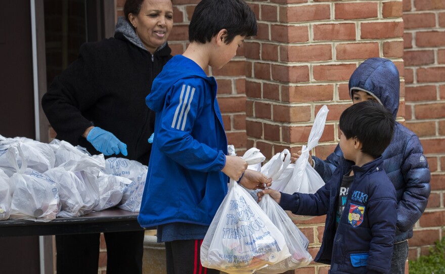 Children collect their free meal at East Silver Spring Elementary School.