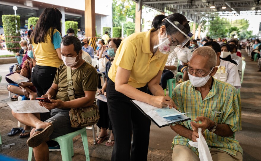 Government clerks check applications from people applying for financial aid during the pandemic.