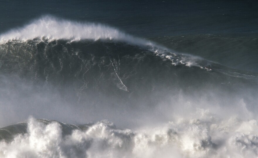 Trust us: Brazilian surfer Rodrigo Koxa is somewhere in this shot of his 80-foot ride last November in Nazaré, Portugal.