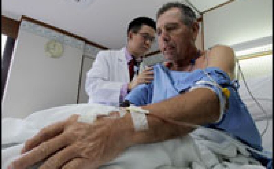 A Thai cardiologist in Bangkok checks a Norwegian patient.