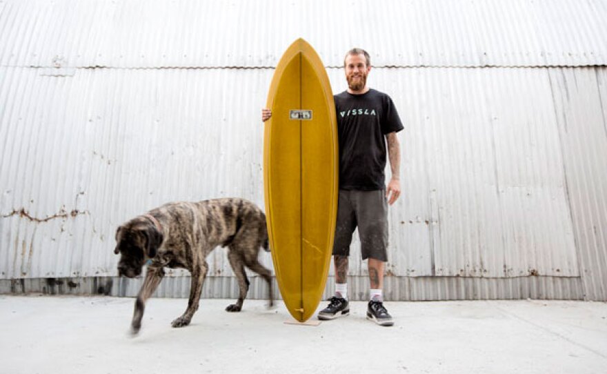 Jeff McCallum with his dog Kimbo and surfboard.