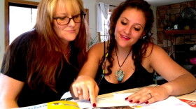 Emily Macri looks over a college brochure with her mother, Maureen O'Brien, in Kingman, Ariz. Macri is transferring to Northern Arizona University so that she can pay in-state tuition.
