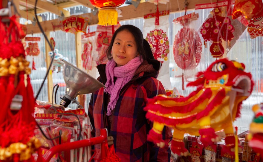Alice Liu, the second-generation owner of Grand Tea and Imports, stands in front of her store in Chinatown.