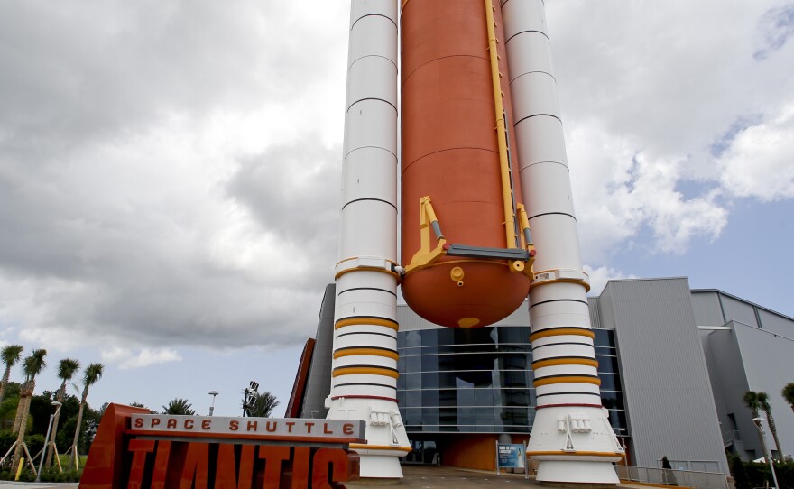 The entrance to the Atlantis exhibit features a replica fuel tank.
