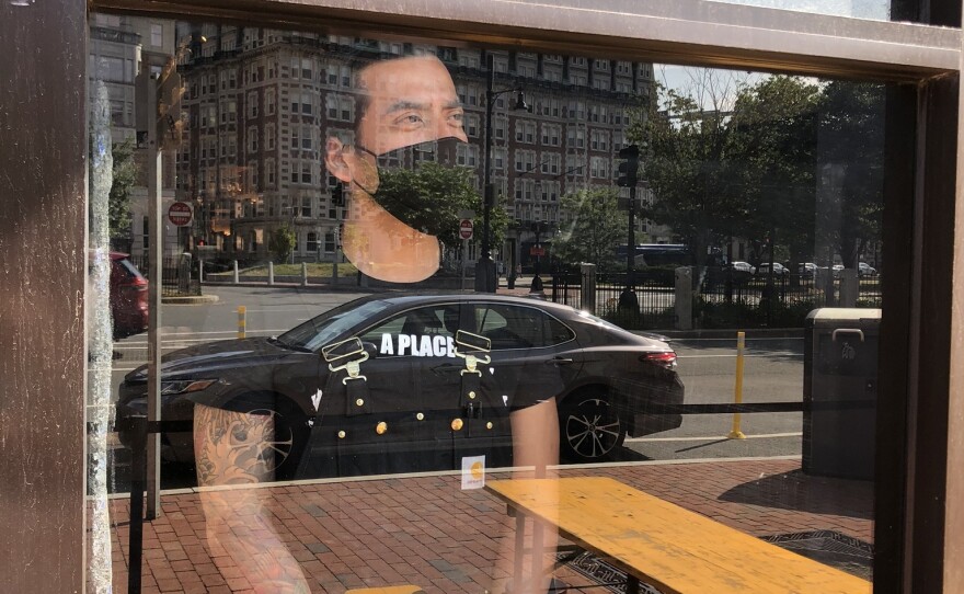 On Cornwall's first day open since the pandemic, business is slow, leaving server Miz Martinez long stretches of time to gaze out the window at the empty streets, in the once-bustling Kenmore Square.