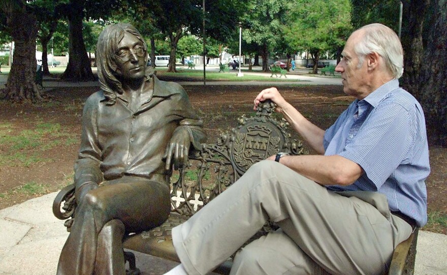 Sir Martin shares a seat with a statue of John Lennon in a park of Havana, Cuba in 2002. Martin made a visit to Cuba to offer conferences on the Beatles and to participate in concerts with Cuban musicians.