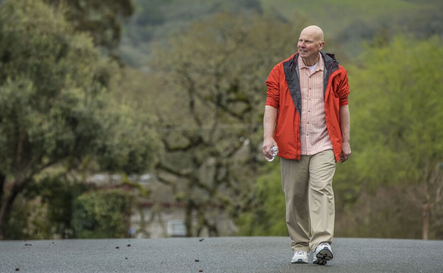 Cancer patient John Krahne has delayed taking a prescribed cancer drug because it was too expensive. He walks near his home in Santa Rosa, Calif.