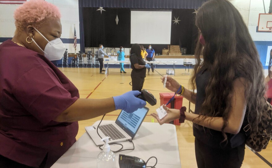 Hillside eighth-grader Amy Muñoz, 13, submits her saliva sample for PCR analysis on Aug. 30. The costs of providing weekly coronavirus testing to all staff and students is covered in part by $11 billion in federal funding in the American Rescue Plan, which is earmarked for testing in K-12 schools.