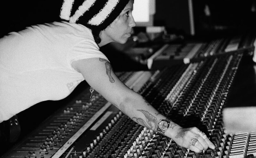 Linda Perry reaching over mixing board during Christina Aguilera session in studio, 2006. Linda Perry Is one of more than 150 producers and artists featured in SOUNDBREAKING.