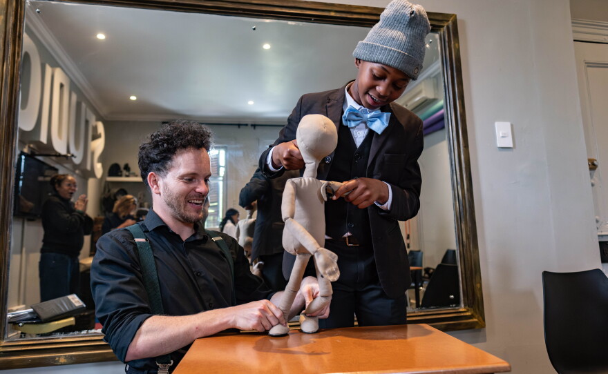 Puppets are part of the curriculum at the College of Magic. Teacher Jesse Brooks shares his puppet mastery with 12-year-old Okuhle Ntshutshe.