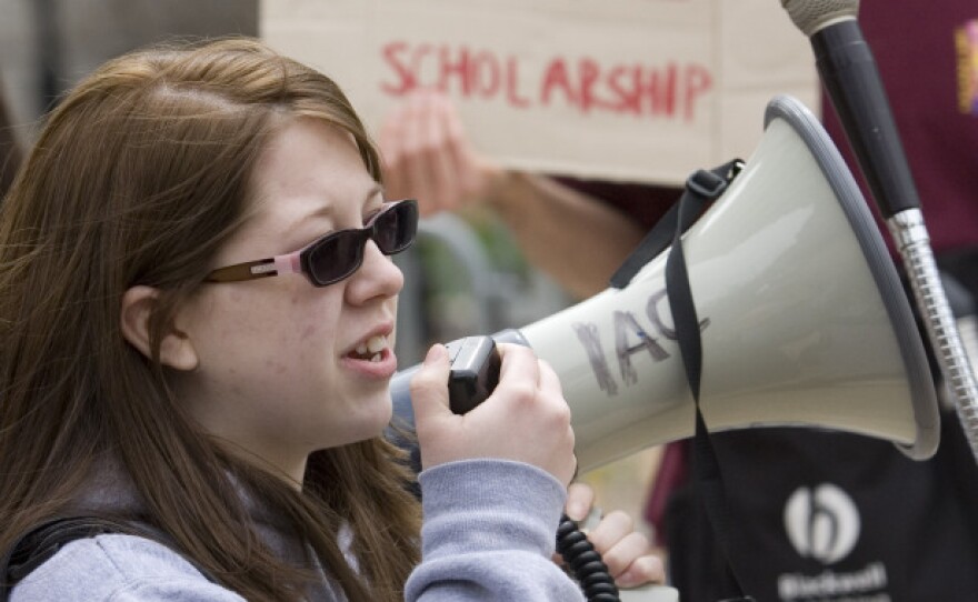 Georgia State University student Heather Sparks tells a crowd how she benefited from the HOPE scholarship during a March 8 demonstration outside the Georgia state capitol.