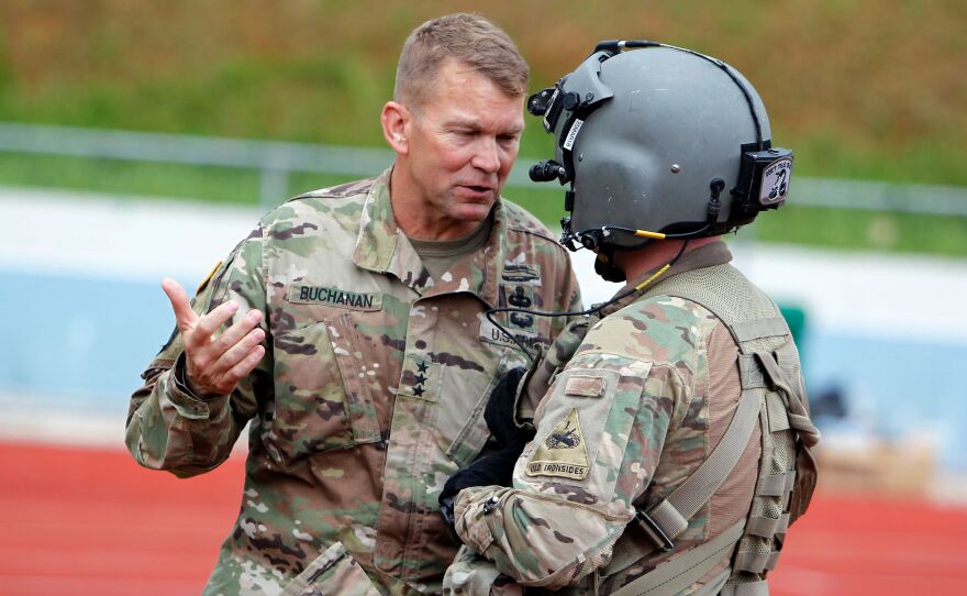 Lt. Gen. Jeffrey Buchanan (left) talks to a U.S. Army helicopter crew member in Barranquitas, Puerto Rico, after a supply delivery mission for residents affected by Hurricane Maria, Oct. 23, 2017.
