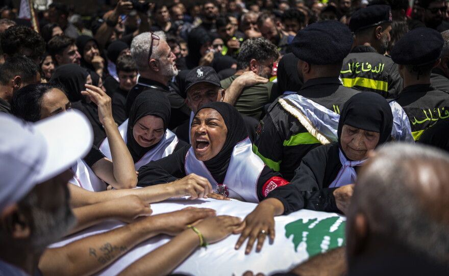 Mourners, relatives and colleagues attend the funeral of Lebanese Civil Defense members Hussein Jaber and Ahmad Noura in Sidon, Lebanon, on May 13.