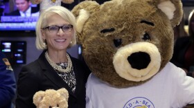 Build-A-Bear Workshop CEO Sharon Price John, poses for photos on the floor of the New York Stock Exchange after ringing opening bell, to highlight National Teddy Bear Day, Wednesday, Sept. 9, 2015.