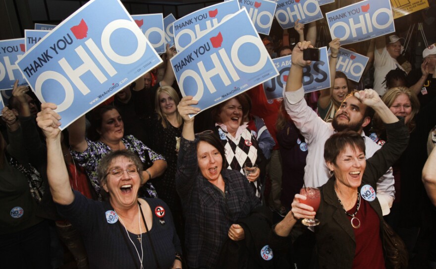Opponents of a law limiting collective-bargaining rights cheer in Cleveland as they hear election results sounding the defeat of the measure in the Ohio general election on Tuesday.