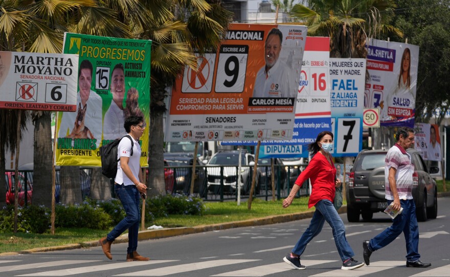 Pedestrians pass election campaign signs for presidential and congressional candidates, before the weekend's election in Lima, Peru, April 10, 2026.
