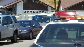 A San Diego police car sits outside of a house Bay Terraces where a family of four was found dead in and around the house on May 24, 2011.