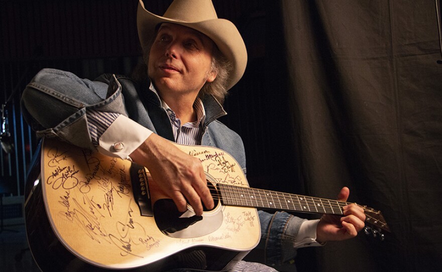 Dwight Yoakam signs Martin D-28 guitar. Yoakam is among the 76 of the 101 country music artists interviewed for the series who signed two Martin D-28 guitars.