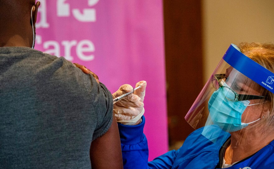 Nurse Keith Grant got his second dose of Pfizer's COVID-19 vaccine on schedule from RN Valerie Massaro in January at the Hartford Convention Center — 21 days after his first immunization.