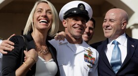 Navy Special Operations Chief Edward Gallagher, center, walks with his wife, Andrea Gallagher, left, and advisor, Bernard Kerik as they leave a military court on Naval Base San Diego, Tuesday, July 2, 2019, in San Diego. A military jury acquitted the decorated Navy SEAL Tuesday of murder in the killing of a wounded Islamic State captive under his care in Iraq in 2017.
