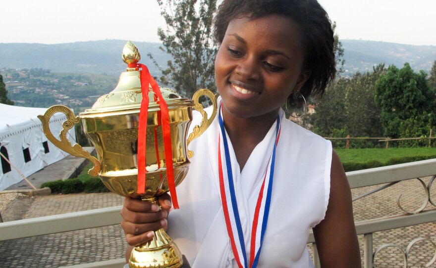 Mireille with one of her debate trophies, on the campus of the Akilah Institute for Women.