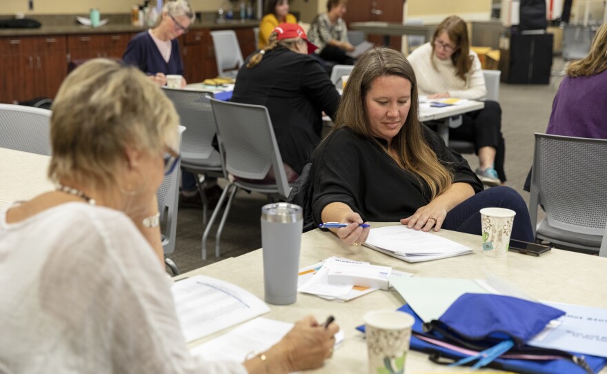 Karen Soderholm, of Holland, left, and Sarah Harrison, of Grand Haven, take a practice test during a poll worker training.