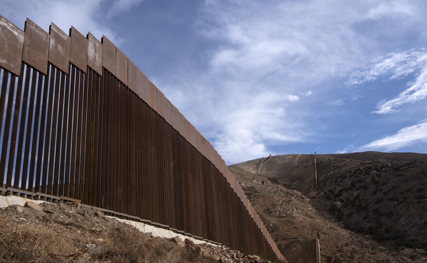 A reinforced section of the U.S.-Mexico border fencing seen in eastern Tijuana, Baja California, Mexico on Jan. 20. President Biden signed an executive action and has halted construction of the massive wall for 60 days.