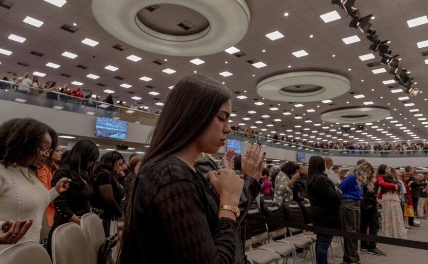 Evangelical churchgoers pray at the Assembleia de Deus Vitória em Cristo Church in the neighborhood of Penha, Rio de Janeiro, on Sunday. Having opened more than 18 new churches since 2020, the church also known by the initials ADVEC is one of the fastest growing evangelical churches in the country.