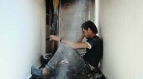 Protagonist Basset Al-Sarout rests in a bombed out apartment building in shattered Homs.