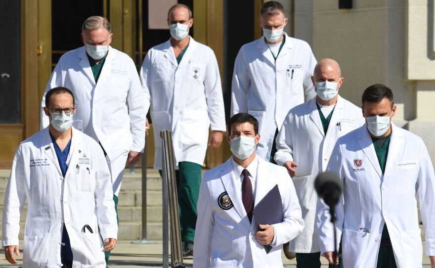 White House physician Sean Conley (center) arrives to answer questions surrounded by other doctors for an update on President Trump's health on Monday.