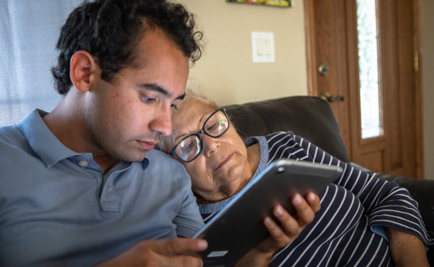 Raul Ureña sits with their grandmother, Olga Raggio, during a break from campaigning at their family's Calexico home, Oct. 8, 2022. 