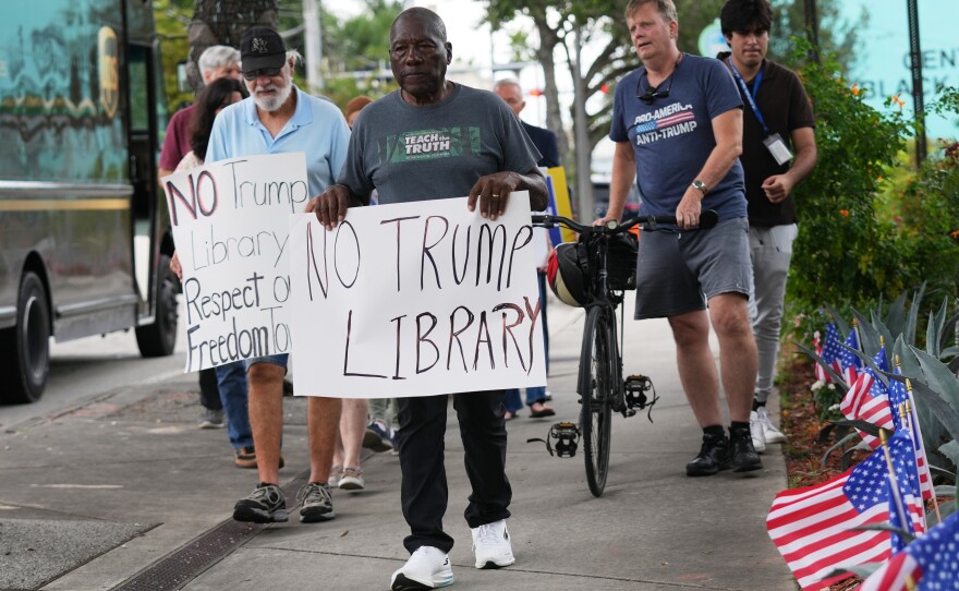 Marvin Dunn, center, and other Miami residents protested the Miami Dade College's donation in November. His lawsuit against it was dropped after trustees held a second vote in December.