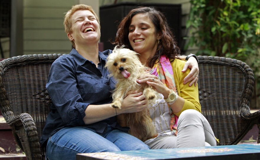 Veterinarians Sophy Jesty (left) and Val Tanco with their dog, Biscuit, at home in Knoxville, Tenn.