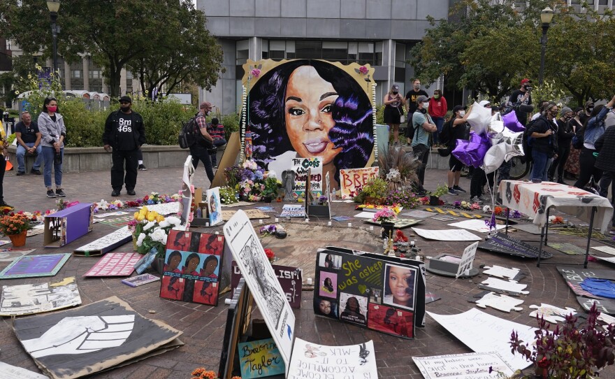 In this Wednesday, Sept. 23, 2020, people gather in Jefferson Square in Louisville, awaiting word on charges against police officers in the death of Breonna Taylor.