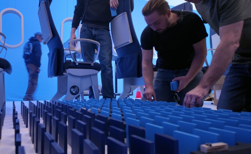 Crew members set up more than 1,000 dominos on the set of United's new safety video.