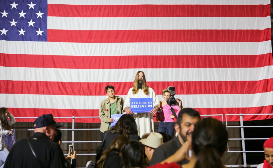 "Jesus," a regular at Sanders rallies, poses with supporters after Sanders' loss in the California primary.