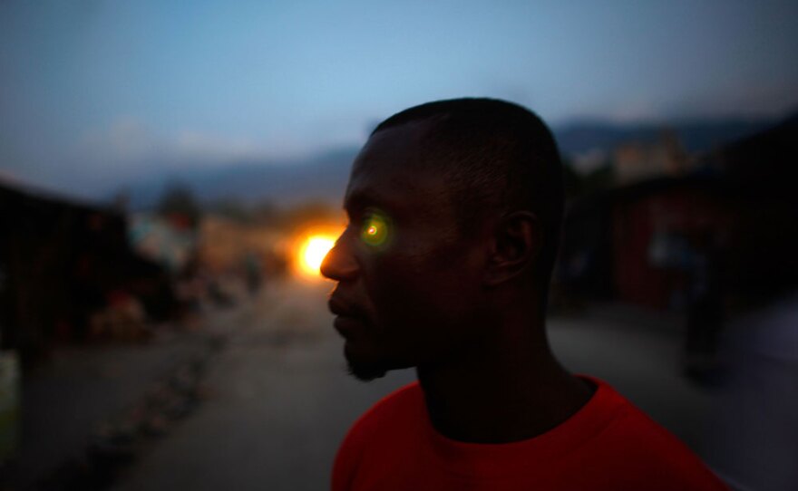 Lofredo Guerrier used to live in the United States. He lost his home in January's earthquake and now lives in a shelter in the community on the median.
